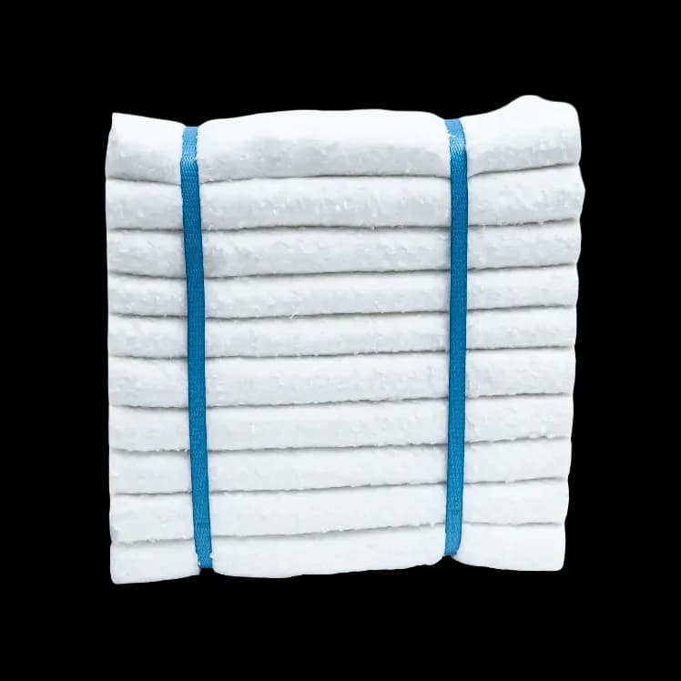 A stack of white ceramic fiber modules tied with two blue plastic straps.