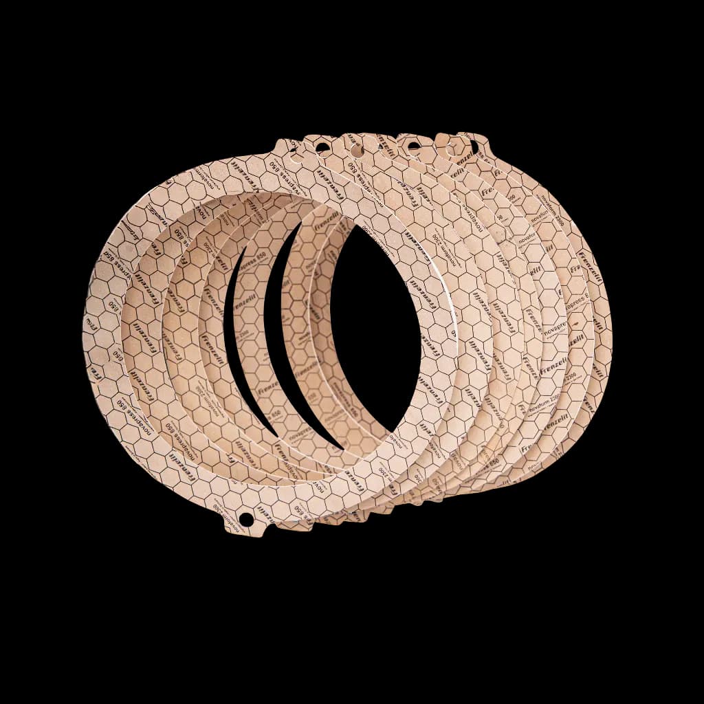 A stack of ring-shaped sealing gaskets in beige, with a hexagonal pattern across the entire surface.
