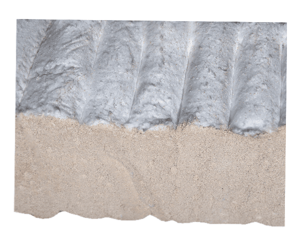 Cross-sectional view of two layers: a beige refractory compound at the base, adhered to a white insulating putty with vertical grooves.