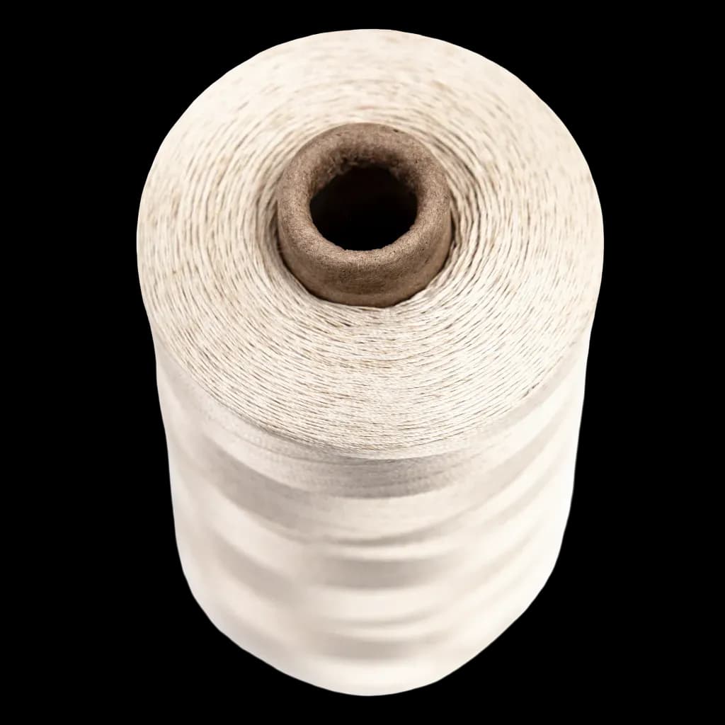 Beige spool of sewing thread for use in insulating textiles and high-temperature applications.